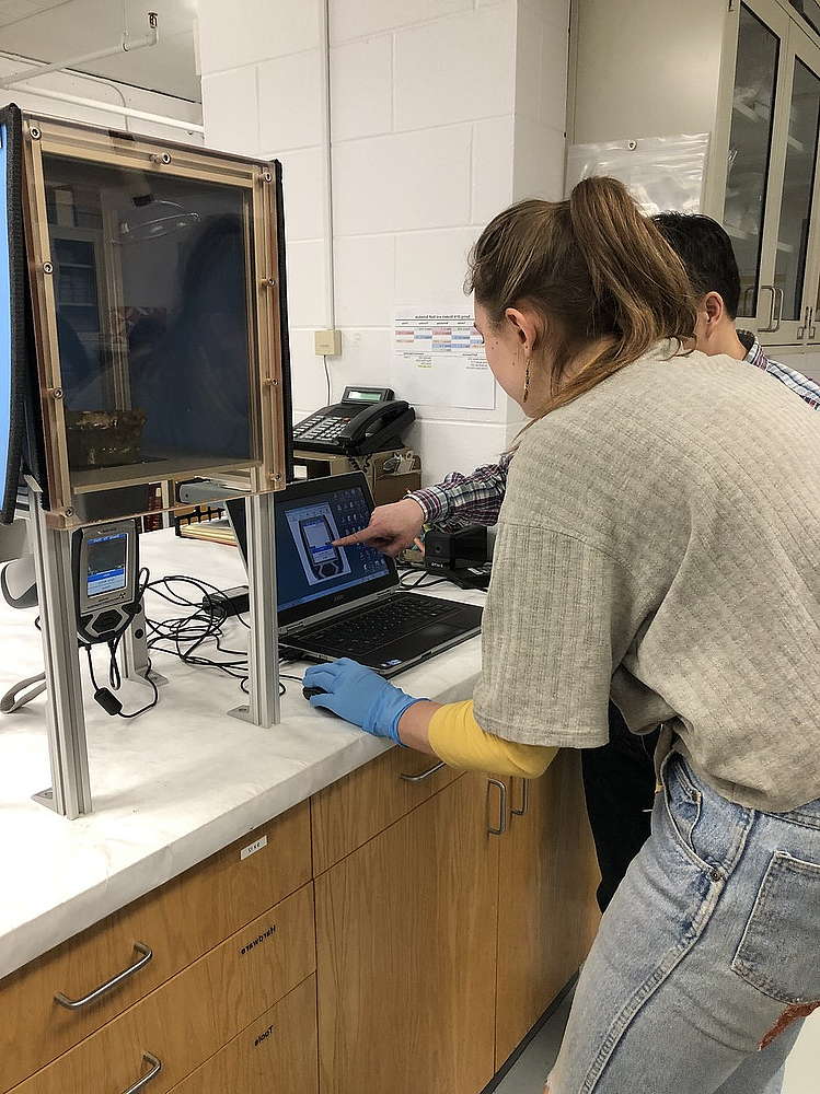 Environmental Geology major Christine Shonnard '19 works with Beloit College Instrumentation Specialist Rongping Deng to analyze by X-ray...