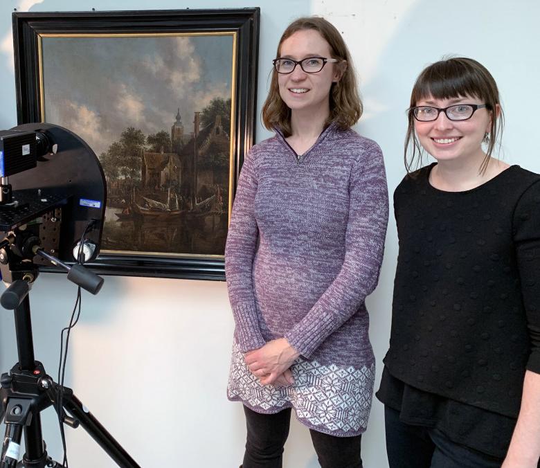 Wright Museum of Art curator Christa Story and chemistry professor Kristin Labby stand next to a painting and an infrared camera