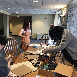 Students painting reusable totebags