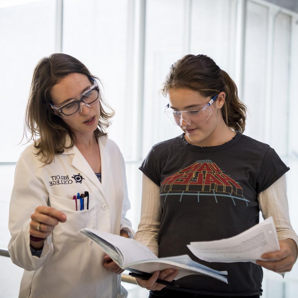 Assistant Professor of Chemistry Kristin Labby reviews the work of a student.