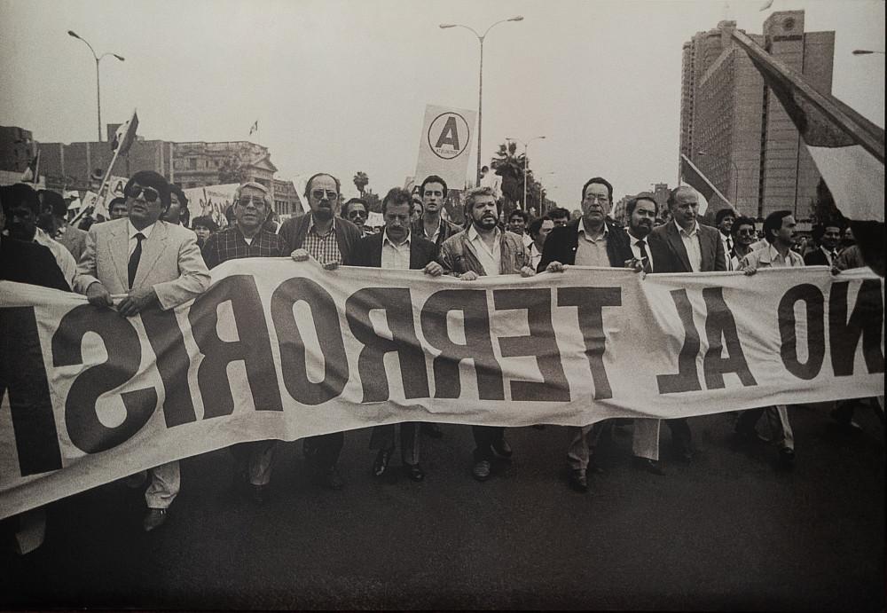 A Lima protest holding the sign reading No al Terrorism.