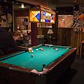 Students play a game of pool in the C-Haus, circa 2015.