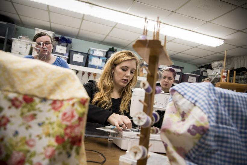 Shelbi Wilkin working in the costume shop.