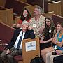 The Alumni Assembly audience, including President Bierman at right, reacts to alumni stories shared in Eaton Chapel during Reunion.